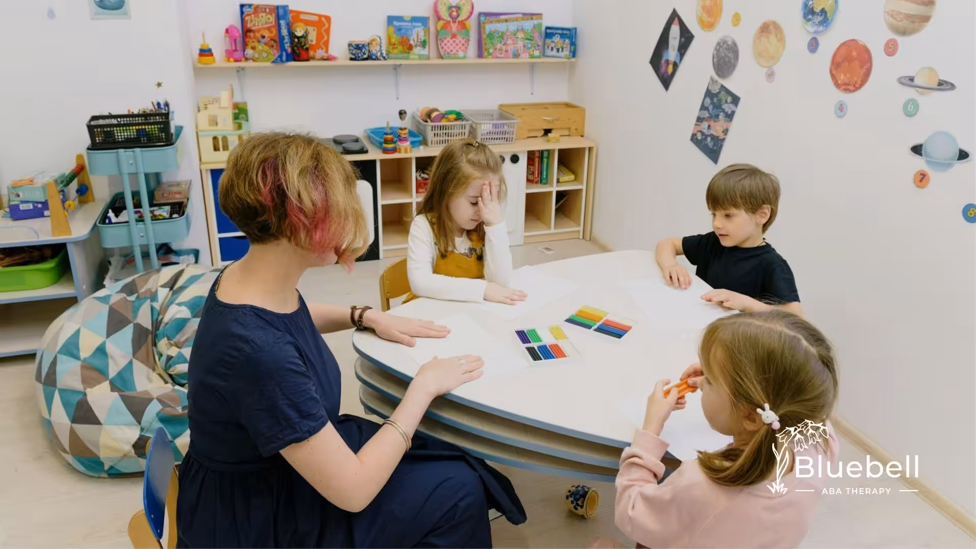 An RBT conducting art activity with autistic children during ABA therapy session in North Carolina.