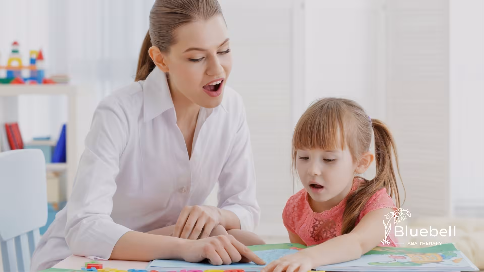 An ABA therapist with a girl with autism, doing ABA Therapy