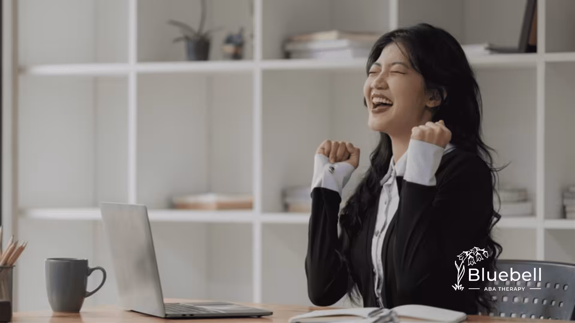 An autistic adult in the office looking happy
