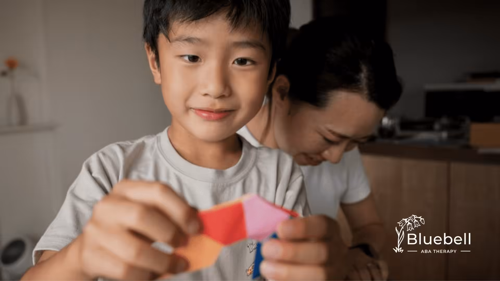 A child playing with colorful paper origami