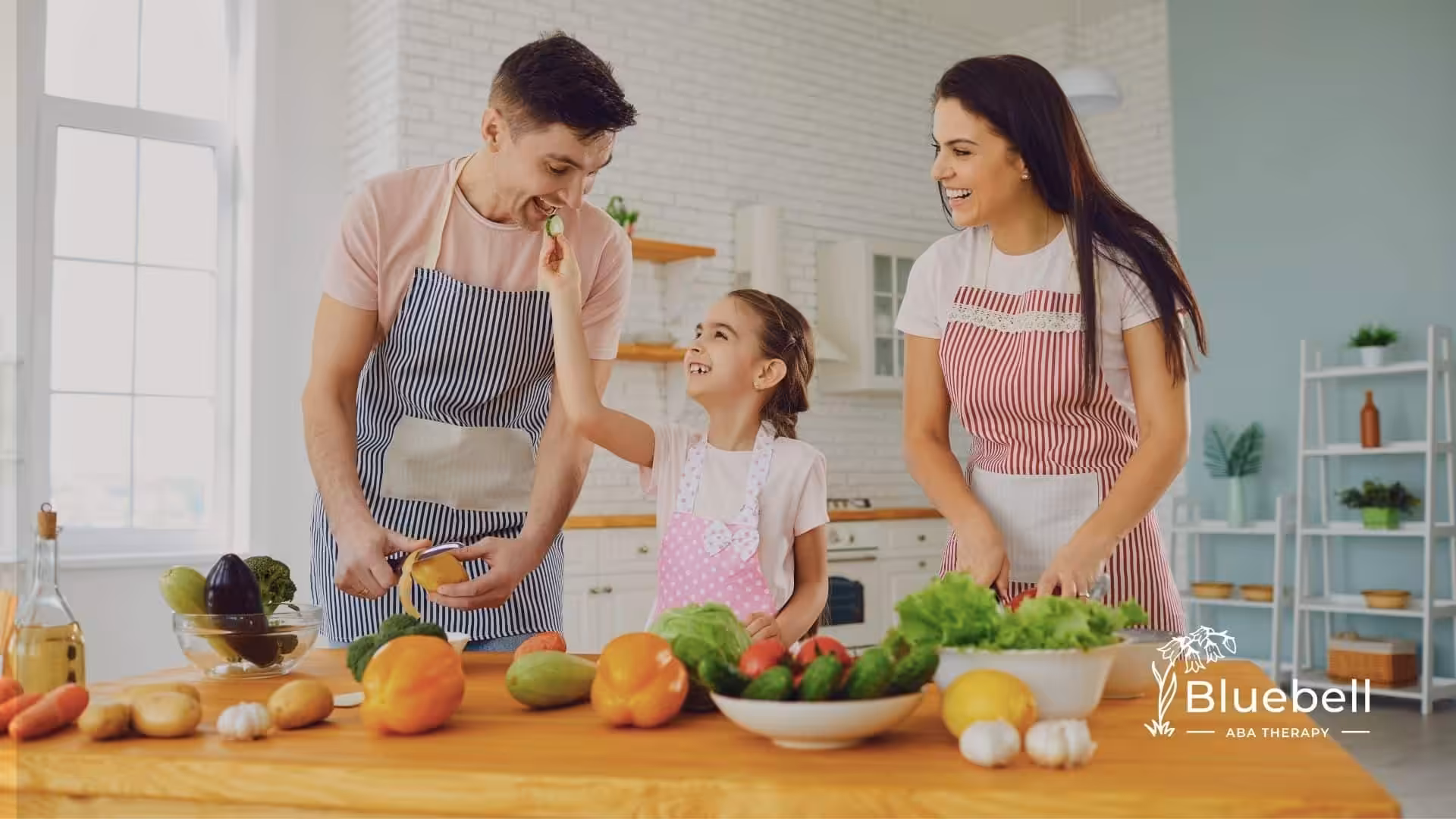 A little girl with her parents preparing foods in the kitchen