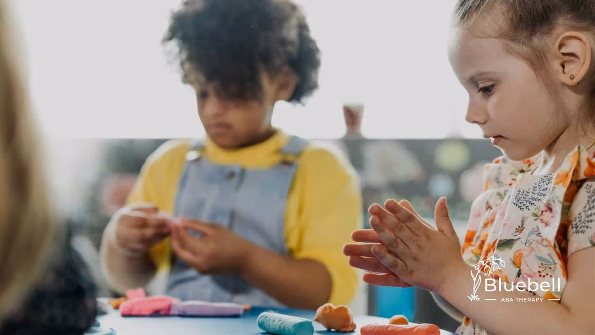 Kids with autism engaging in a playdough activity during ABA therapy session in North Carolina.