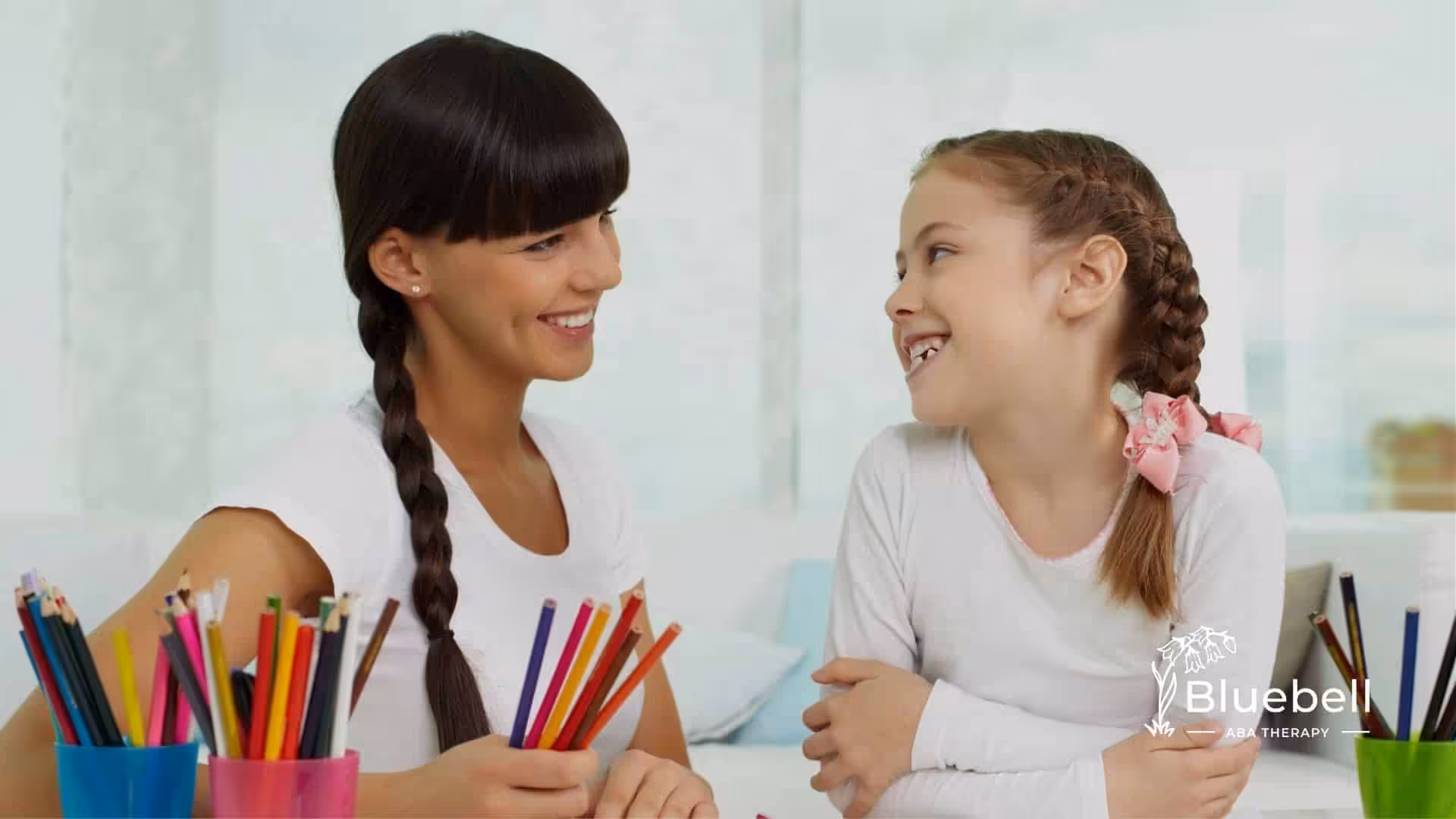 A BCBA and child engaged in a drawing activity.