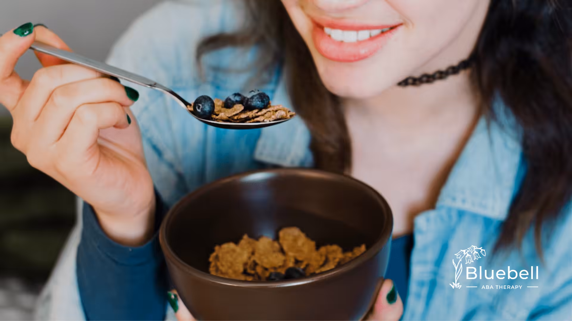 An autistic adult eating a bowl of fruits and cereal