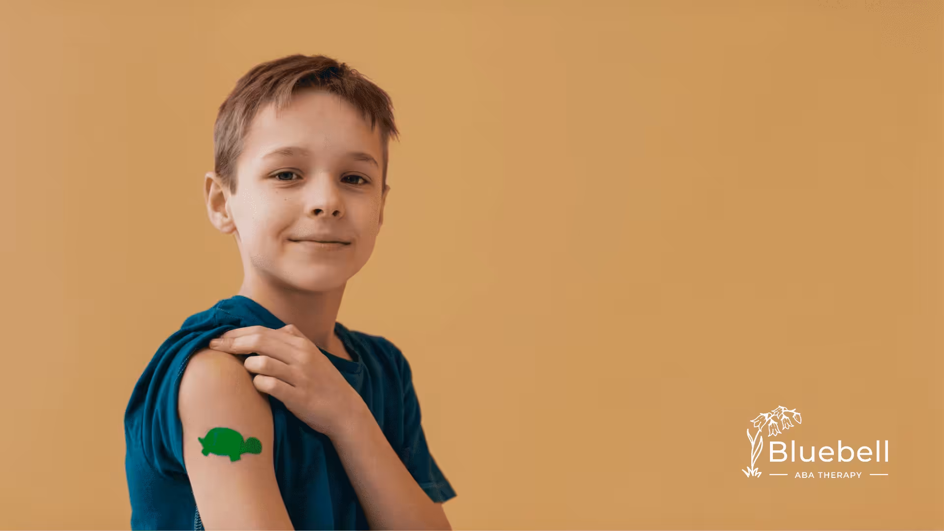 A boy showing his arm with bandage