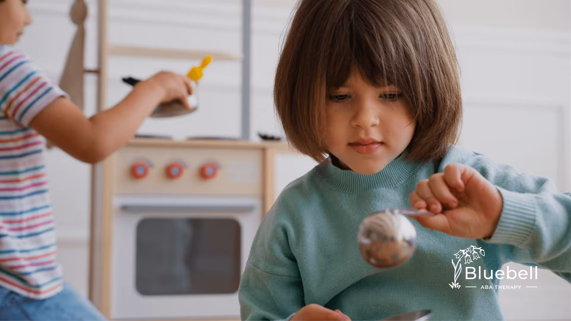 Two children with autism playing with sensory toys during ABA therapy