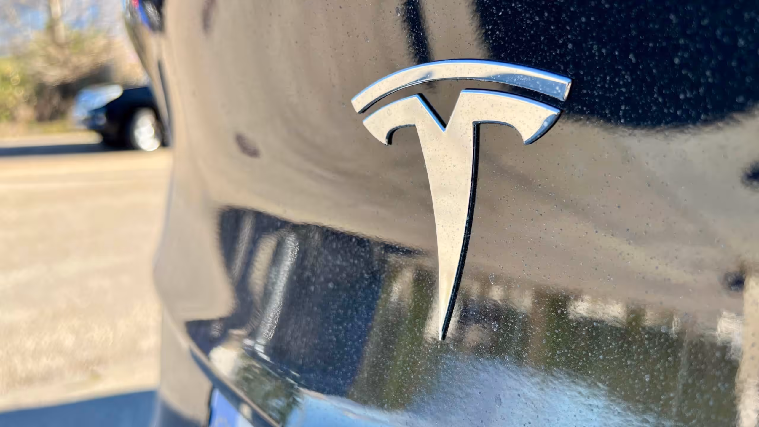 A Tesla car emblem on car hood