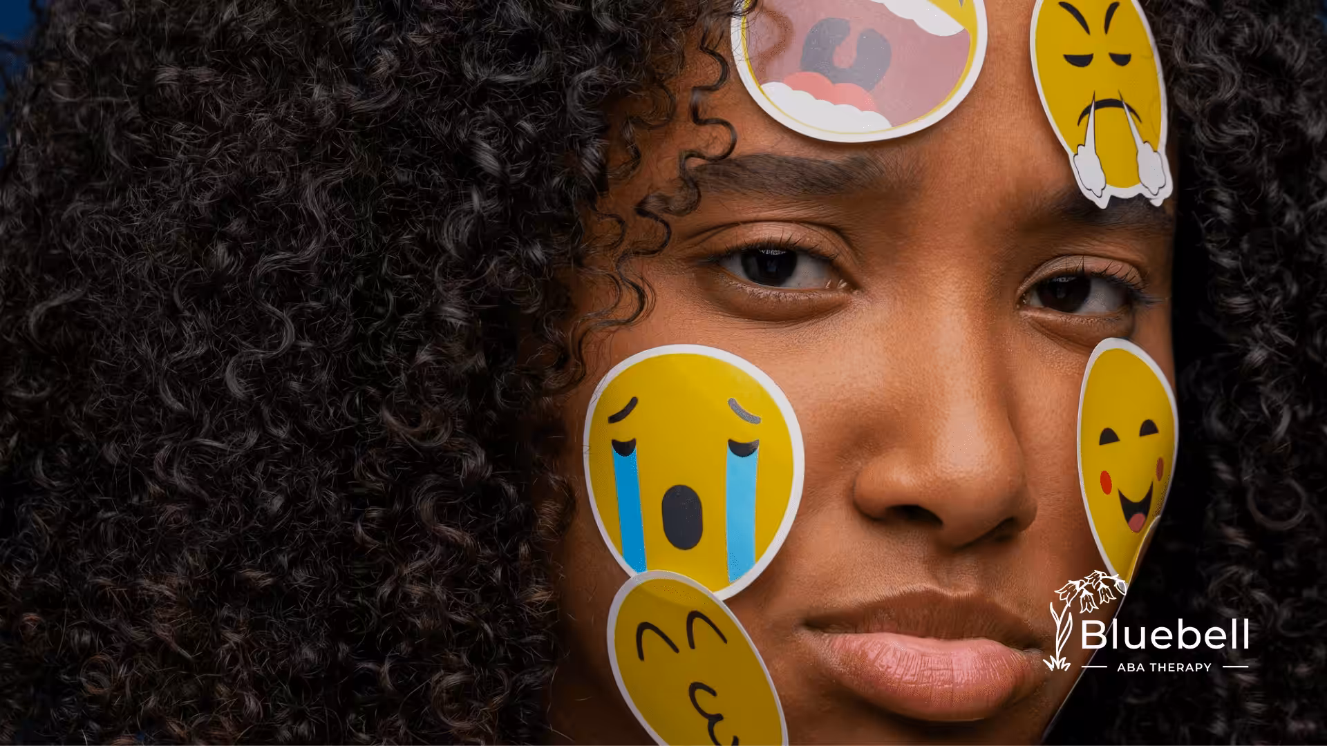 A woman with emoticon stickers on her face