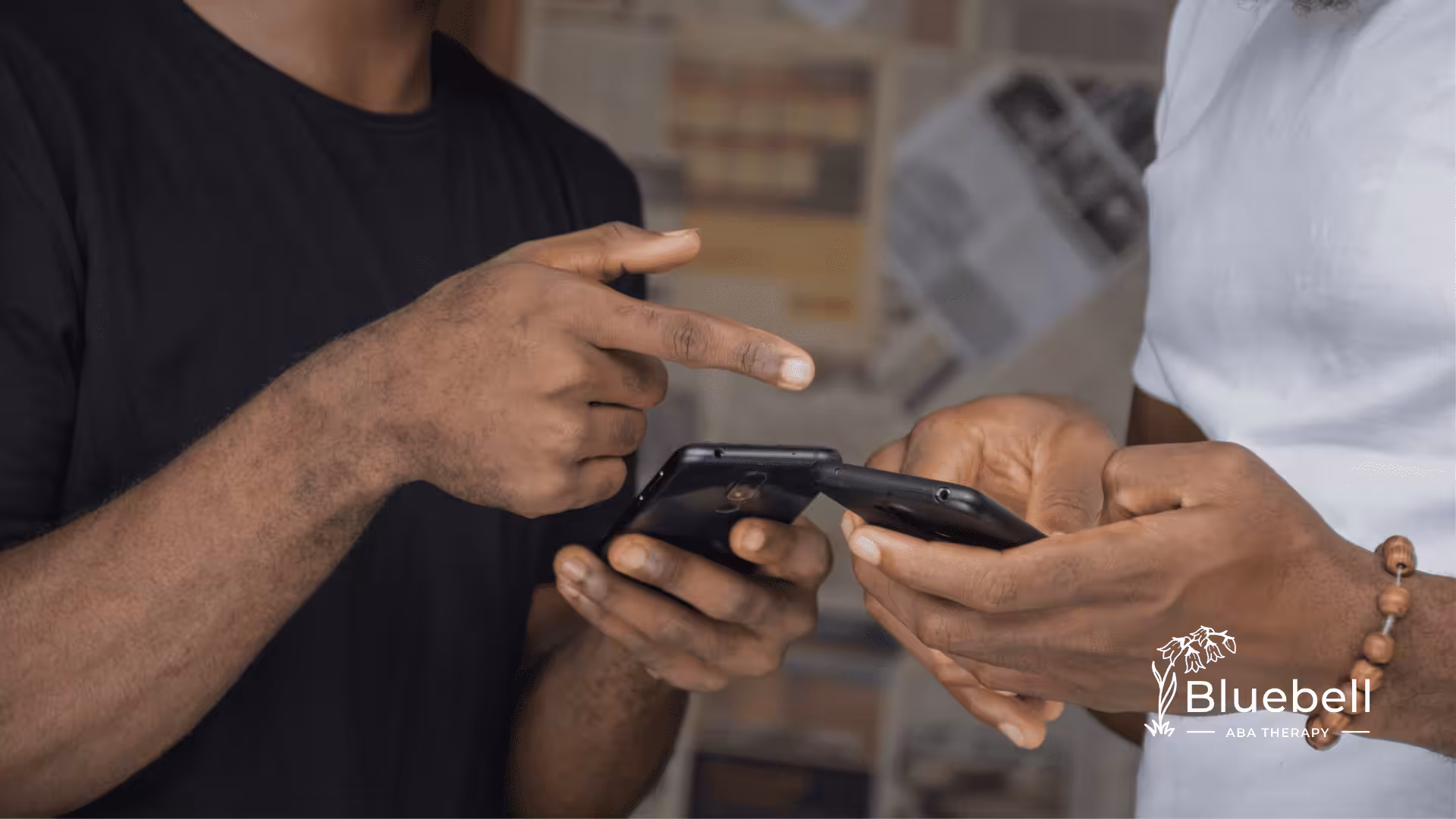 Two adults looking at a mobile phone