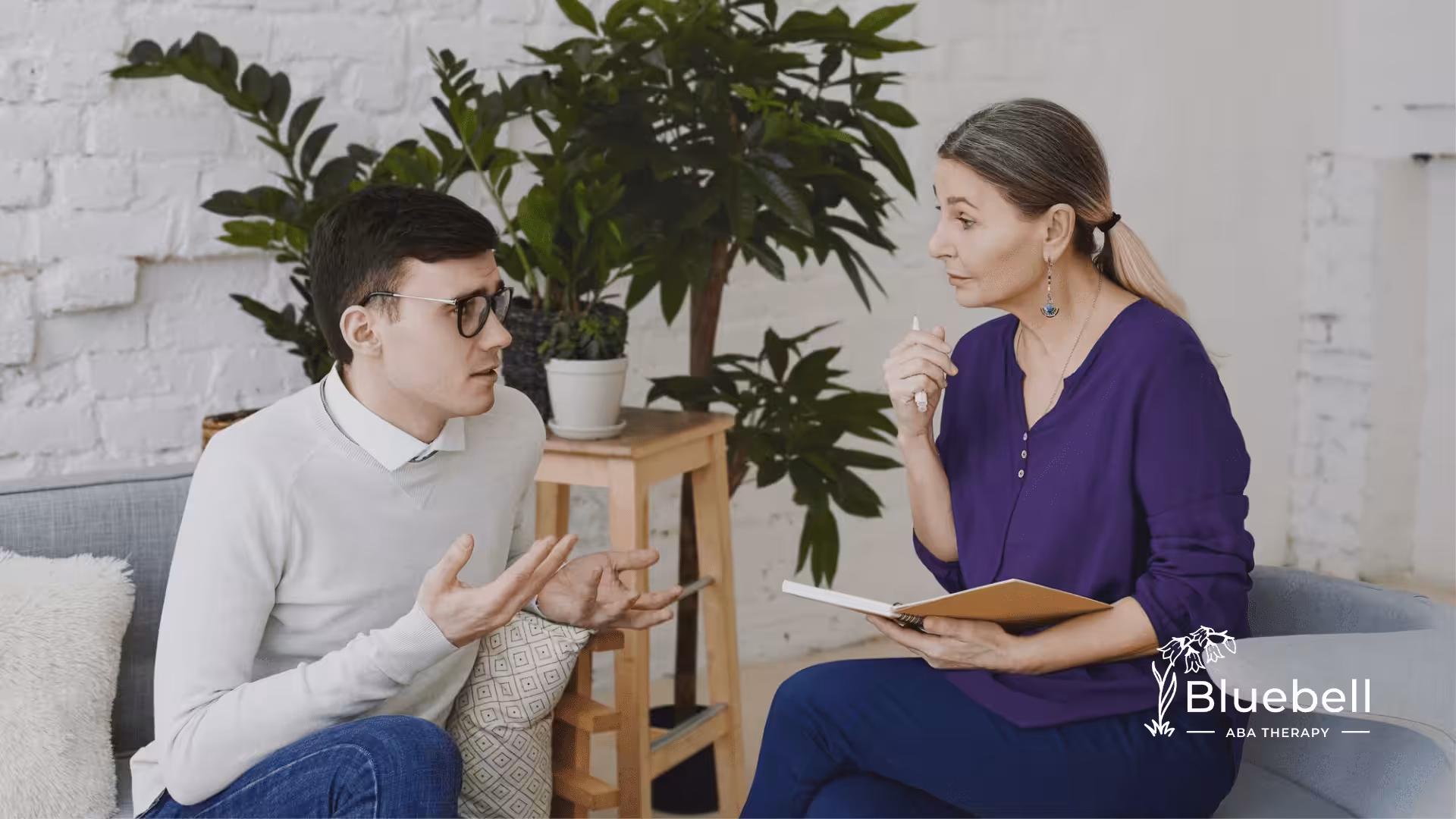 An adult with autism and a speech therapist talking