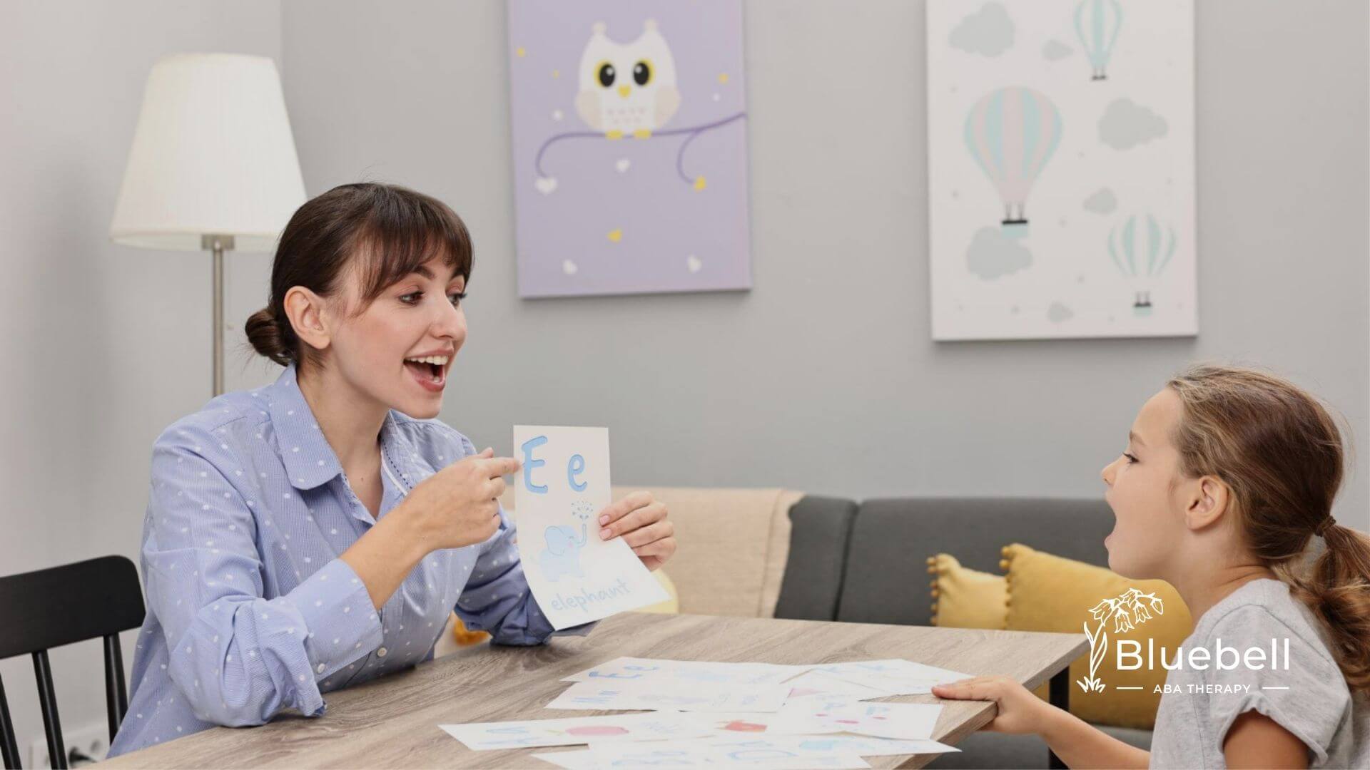 ABA therapist teaching a child letters.