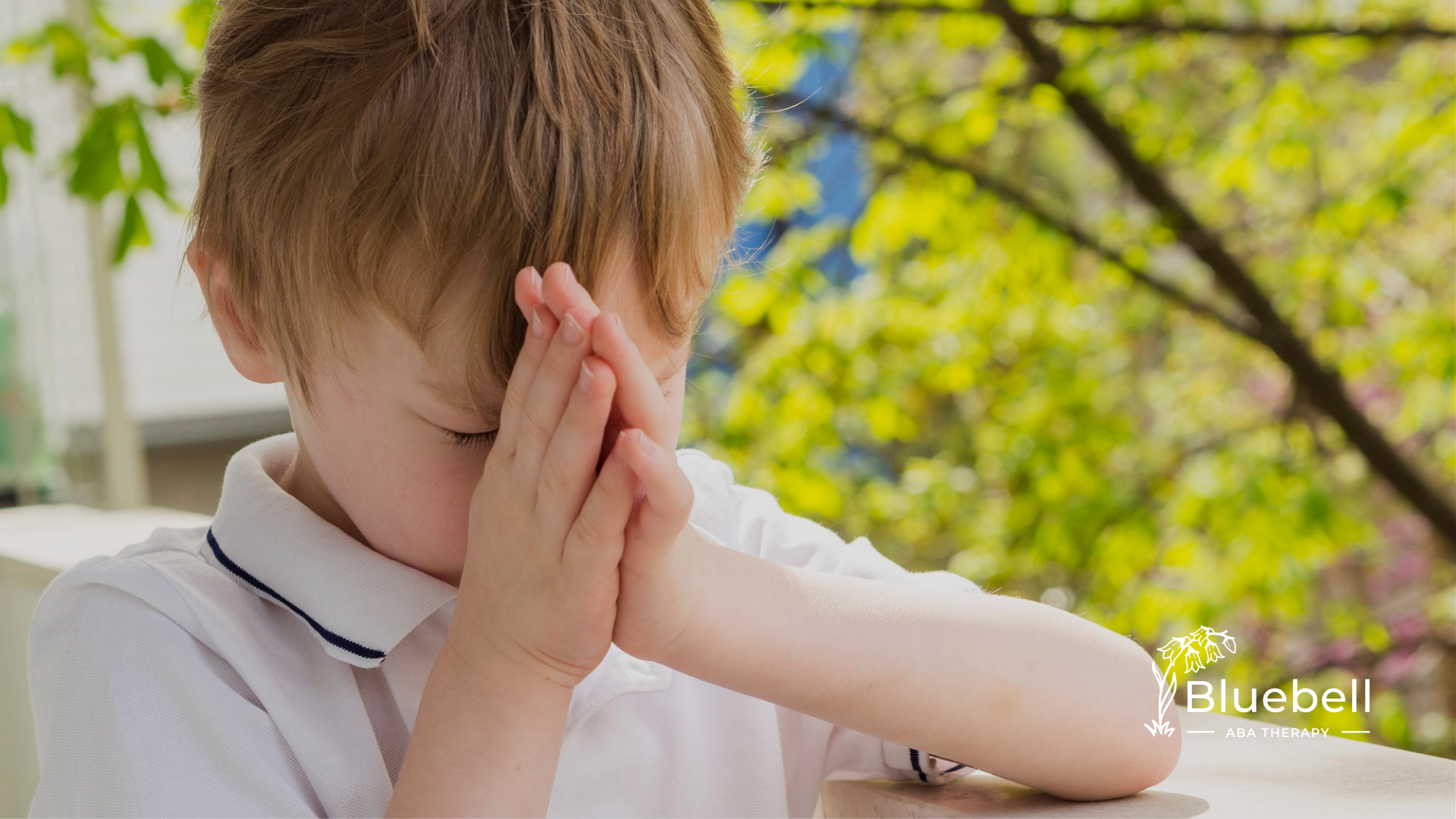 A child with autism covering his face