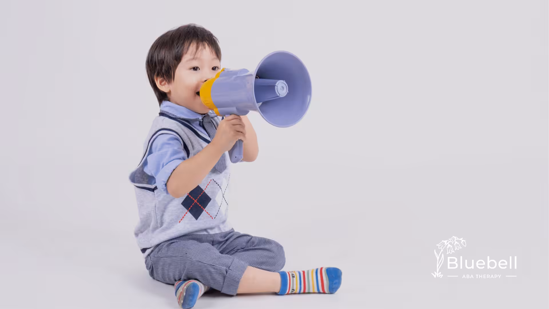 A kid with autism playing with megaphone