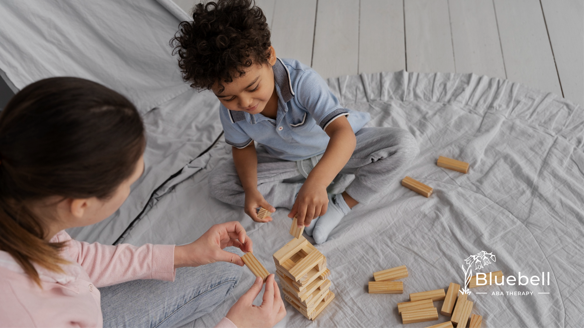 An autistic child and his ABA therapist during their child-led ABA therapy