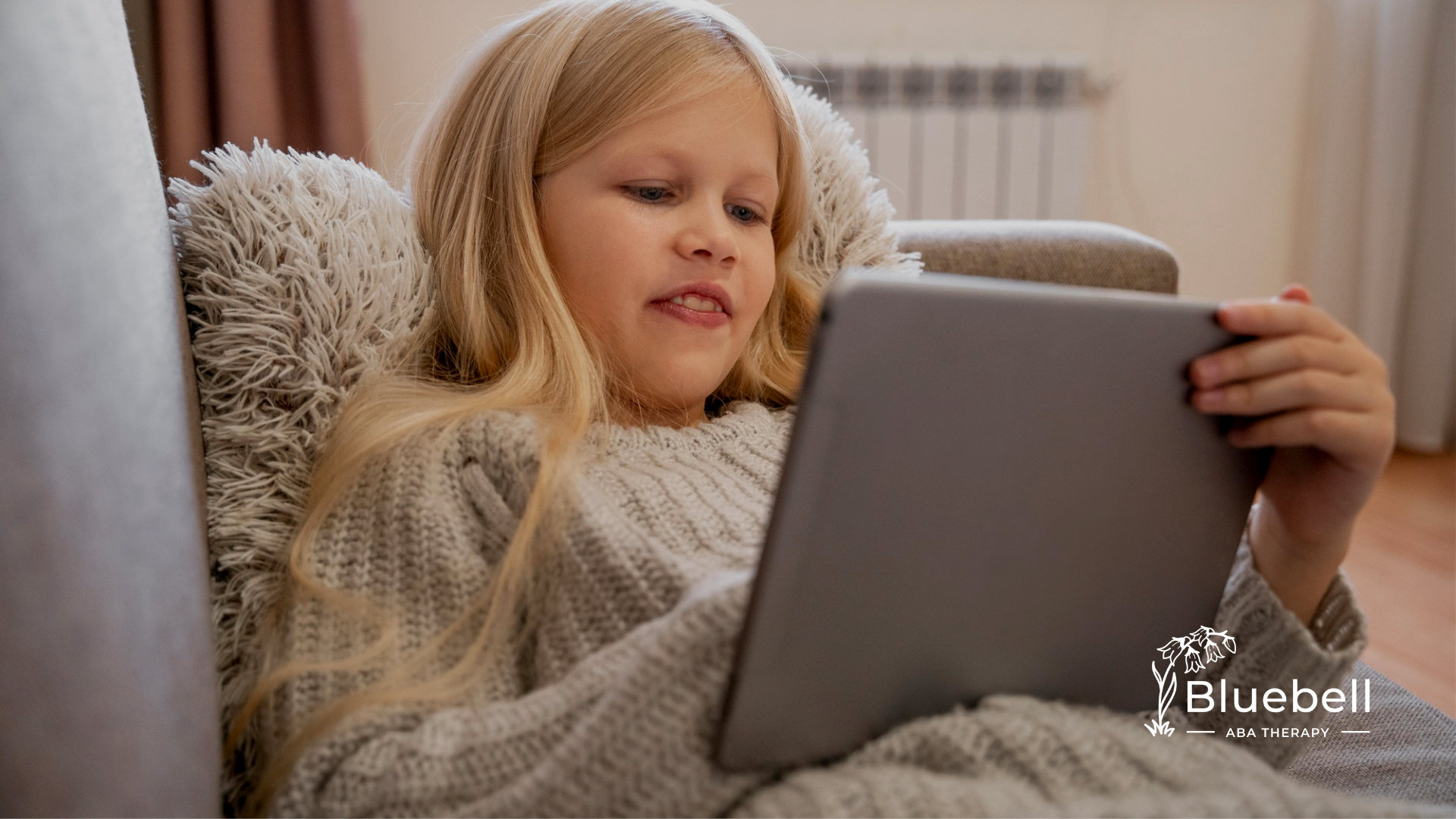 A child with autism is using a mobile tablet
