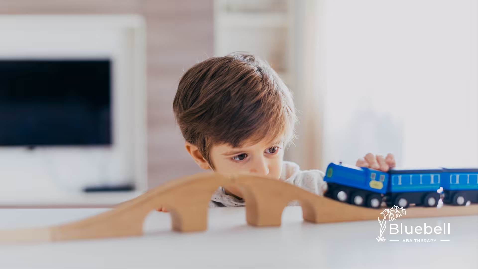 An autistic child playing with a train toy