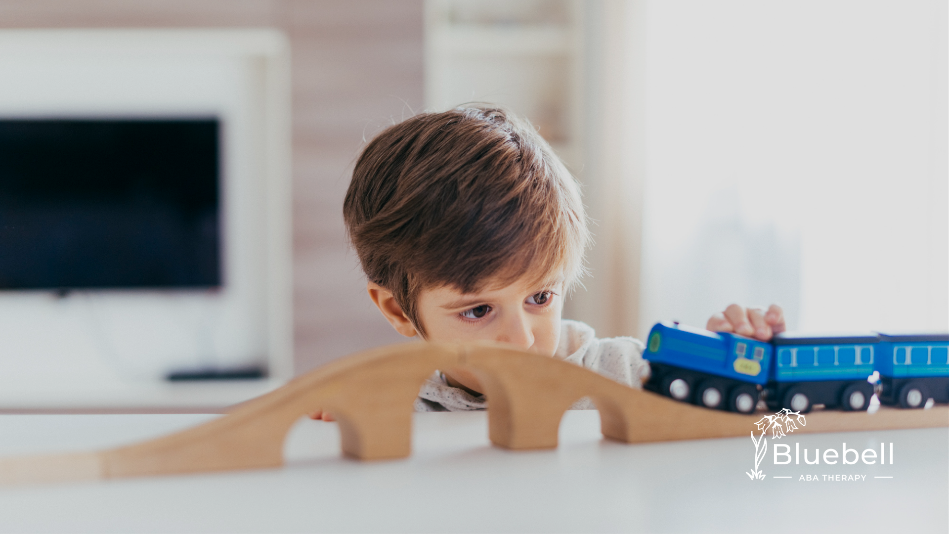 An autistic child playing with a train toy