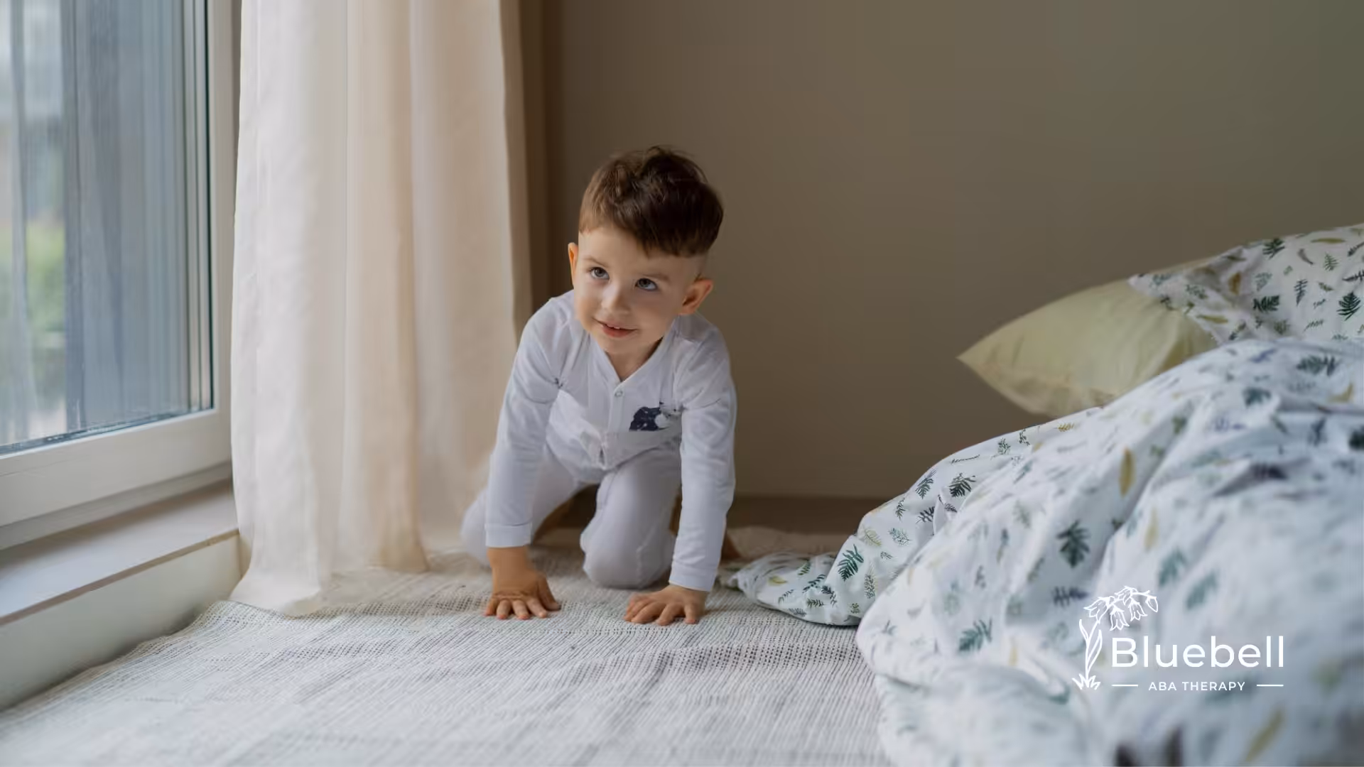 A kid with autism climbing on the bed