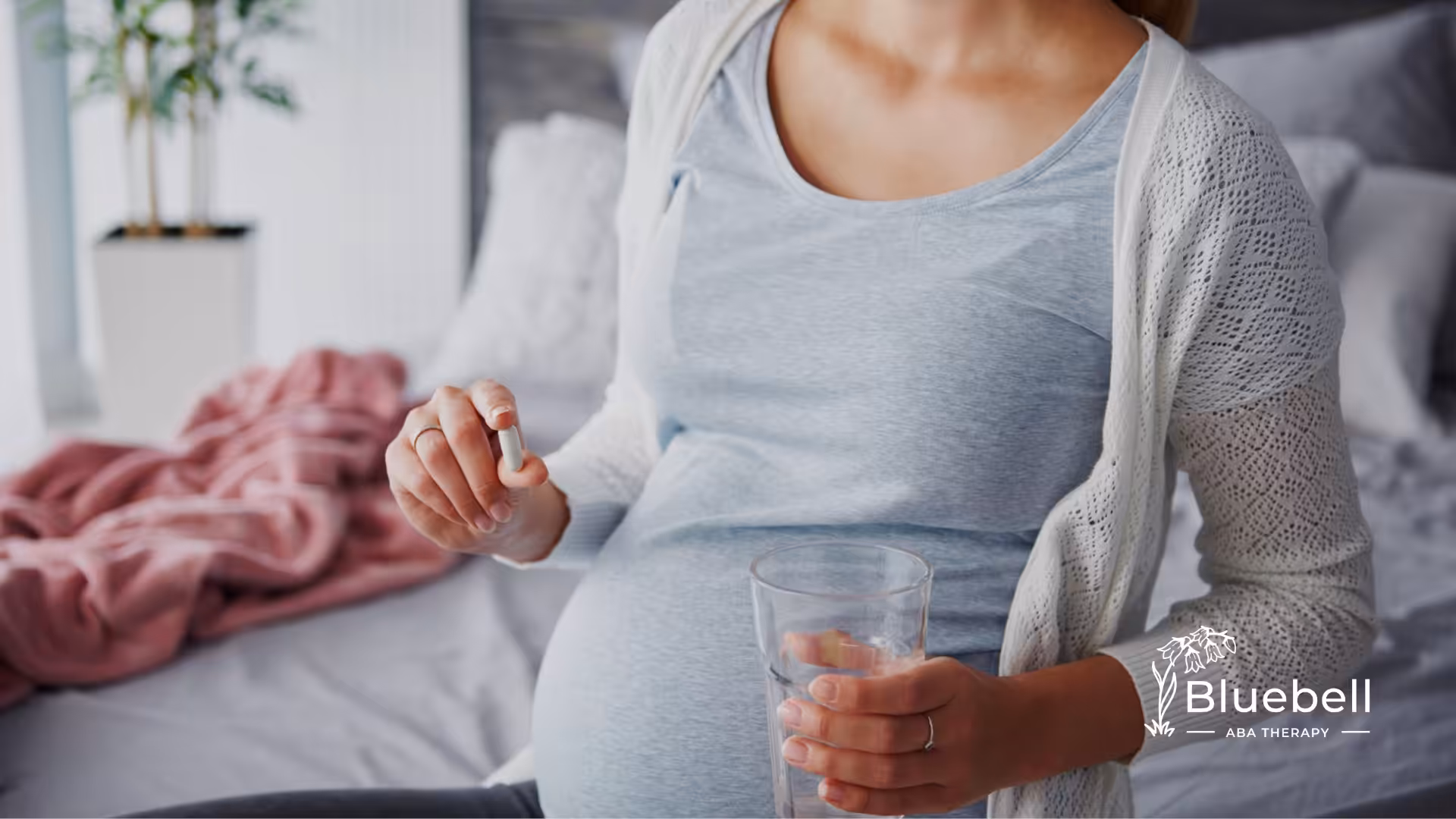 A pregnant woman taking a pill