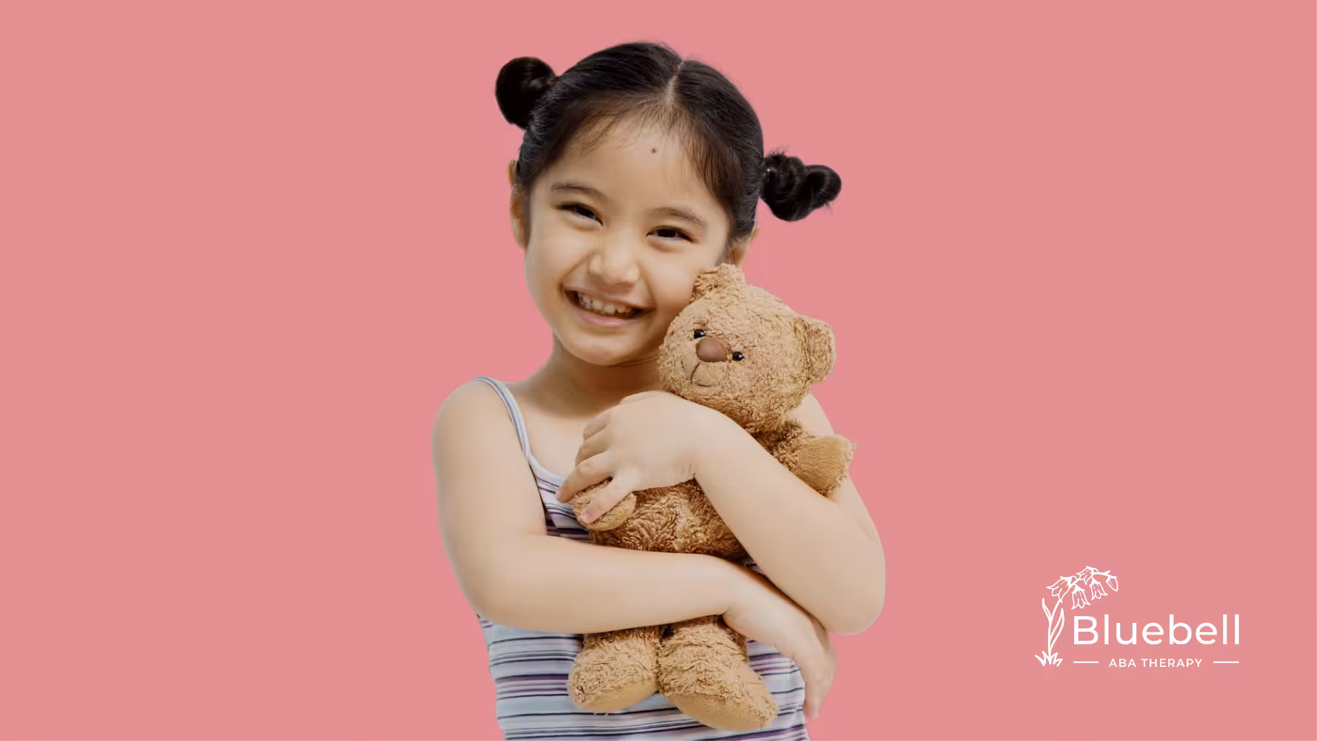 An allistic kid holding a teddy bear