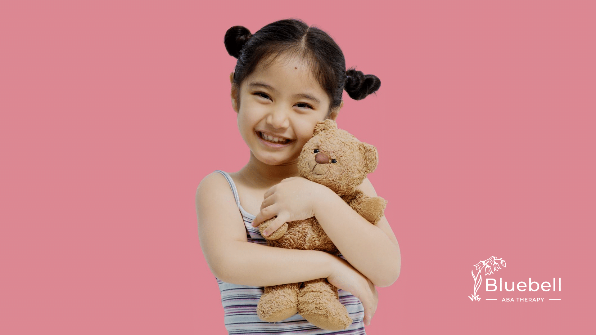 An allistic kid holding a teddy bear