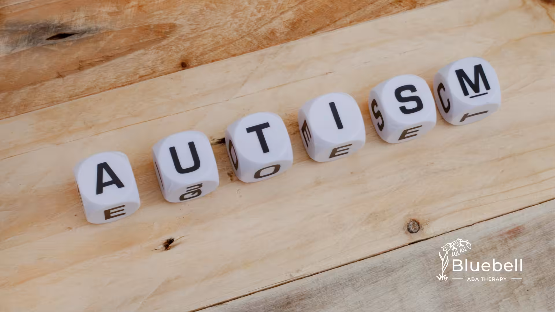 Letter dice that spells the word "autism"