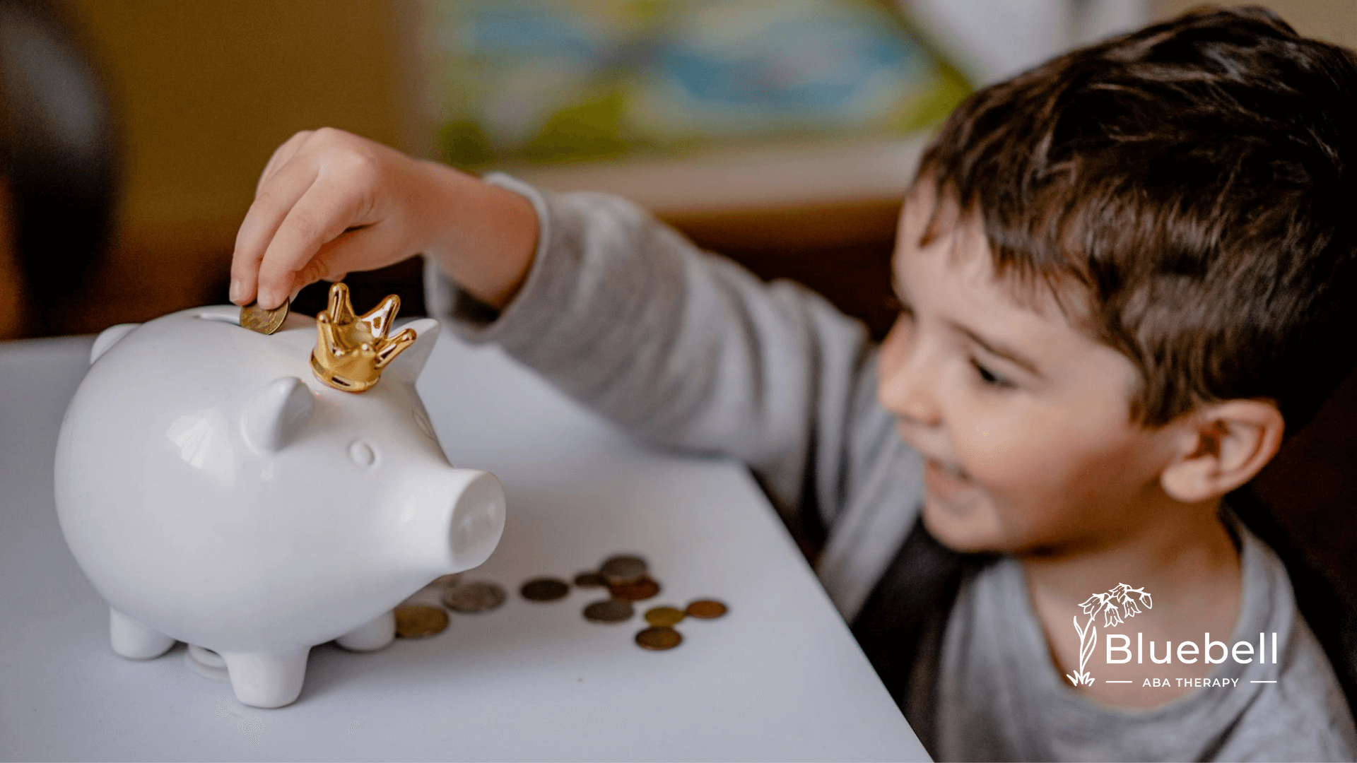 Autistic boy places coins in crowned piggy bank, enjoying a playful moment of learning to save after ABA therapy.