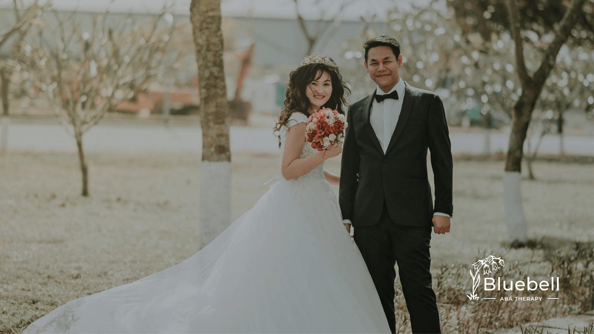 Autistic bride and autistic groom posing for a wedding photo outdoors after ABA therapy in North Carolina.