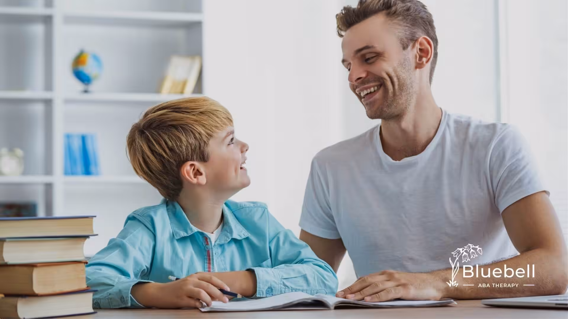 A BCBA and autistic child sitting together reading a book during ABA therapy.