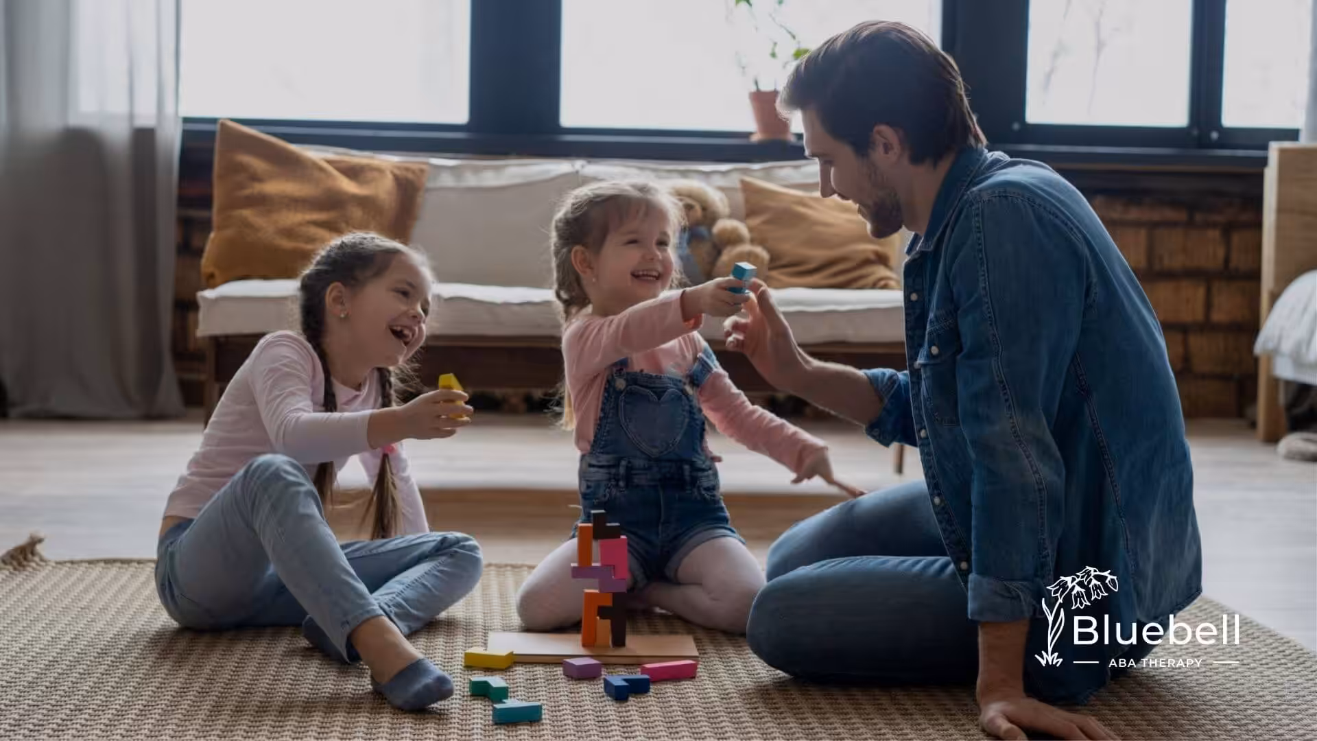 Parent interacting with children during play-based ABA therapy activity.